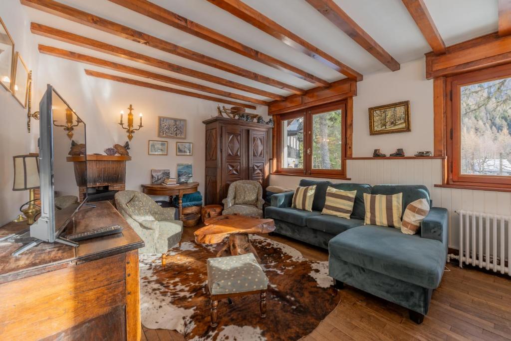 a living room with a couch and a tv at Chalet Ecureuil Family retreat w/ Garden & Fireplace - Happy Rentals in Chamonix