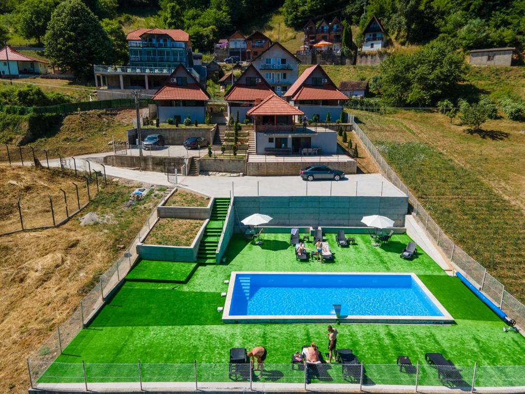 an overhead view of a swimming pool with green grass at Apartmani Maja in Rastište