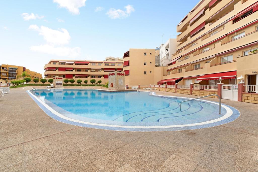 a large swimming pool in the middle of a building at La Casita de Edu in Puerto de Santiago