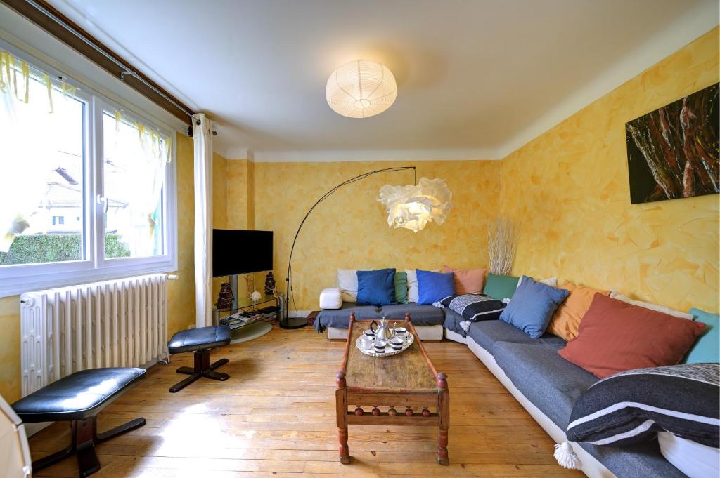 a living room with a couch and a table at Luchon Maison Flor in Luchon