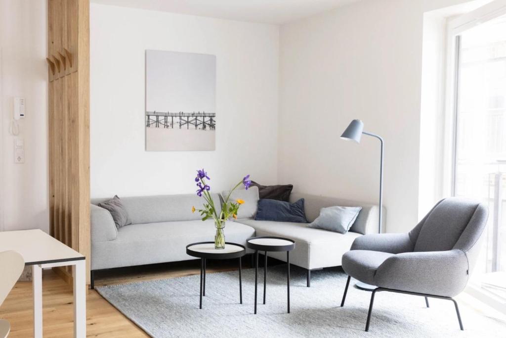a living room with a couch and a chair and a table at Steuerbord in Böhl