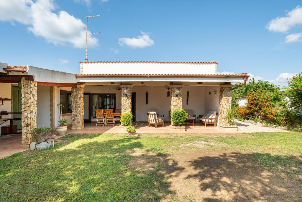 a house with a patio and a yard at Villa Rita in Flumini di Quartu