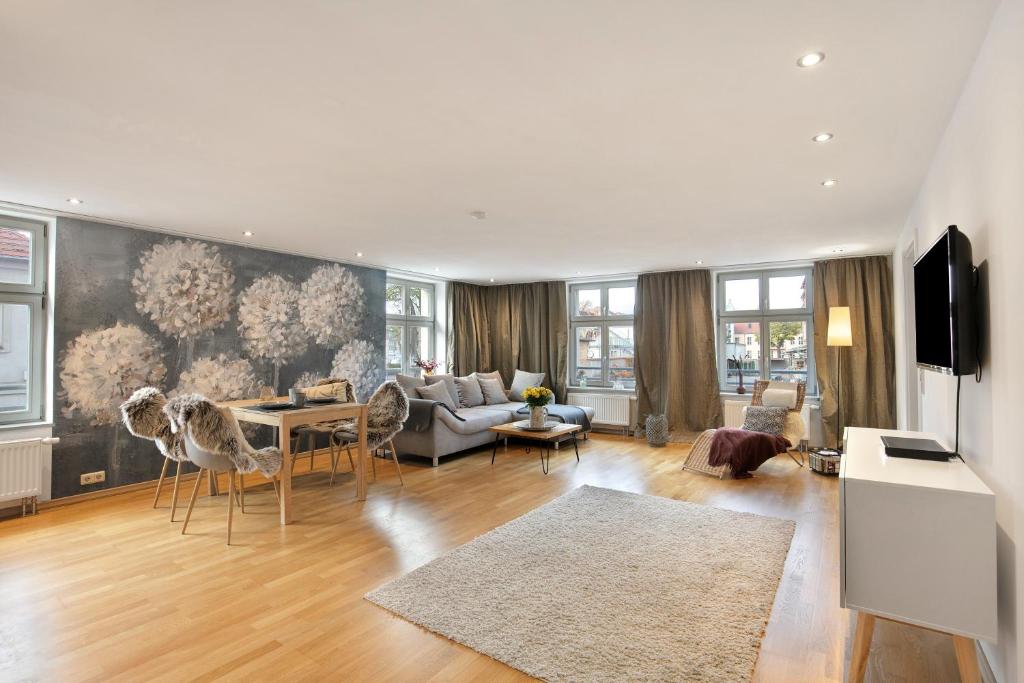 a living room with a couch and a table at Klosterperle in Neuruppin
