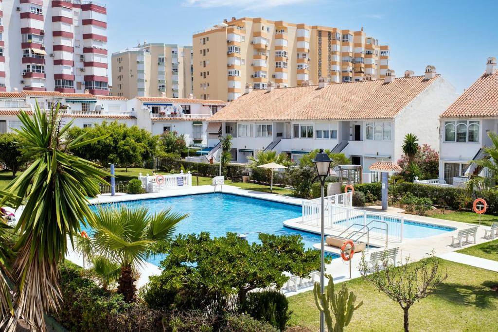 an image of a swimming pool at a resort with tall buildings at Estudios 88 in Torrox