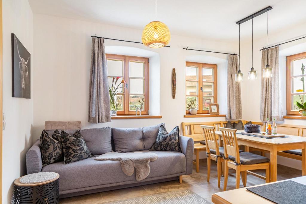 a living room with a couch and a table at Ferienwohnung z'Dandlberg in Tittmoning