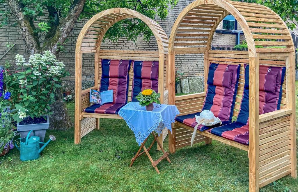 two wooden gazebos with chairs and a table at Ferienwohnung 2 Soltau in Soltau