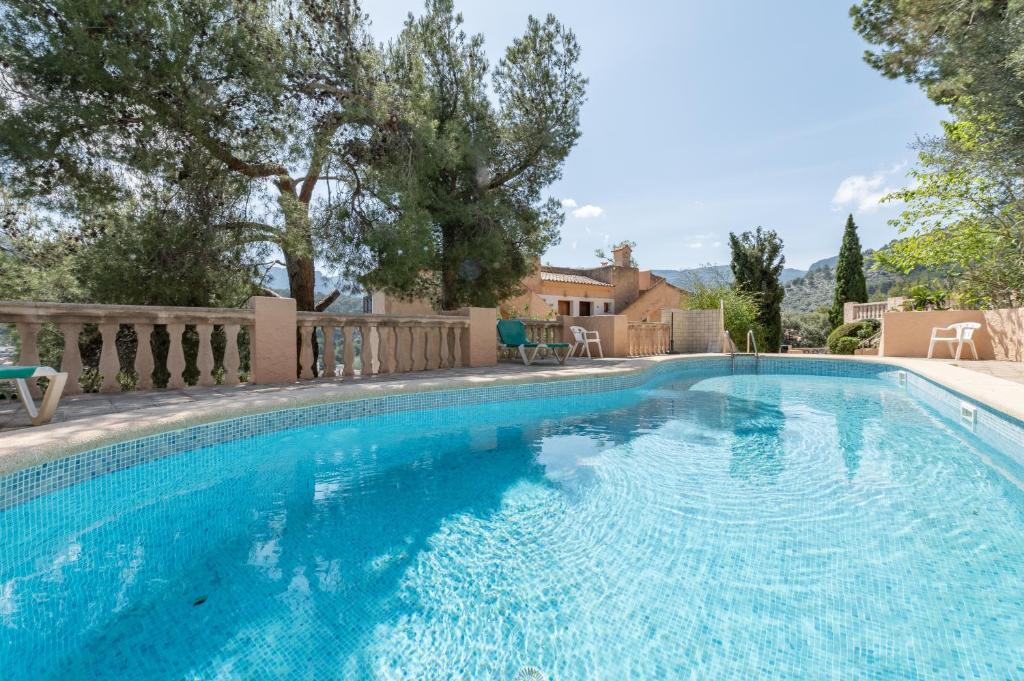 a swimming pool with blue water in a yard at Montemar 36 in Port de Soller