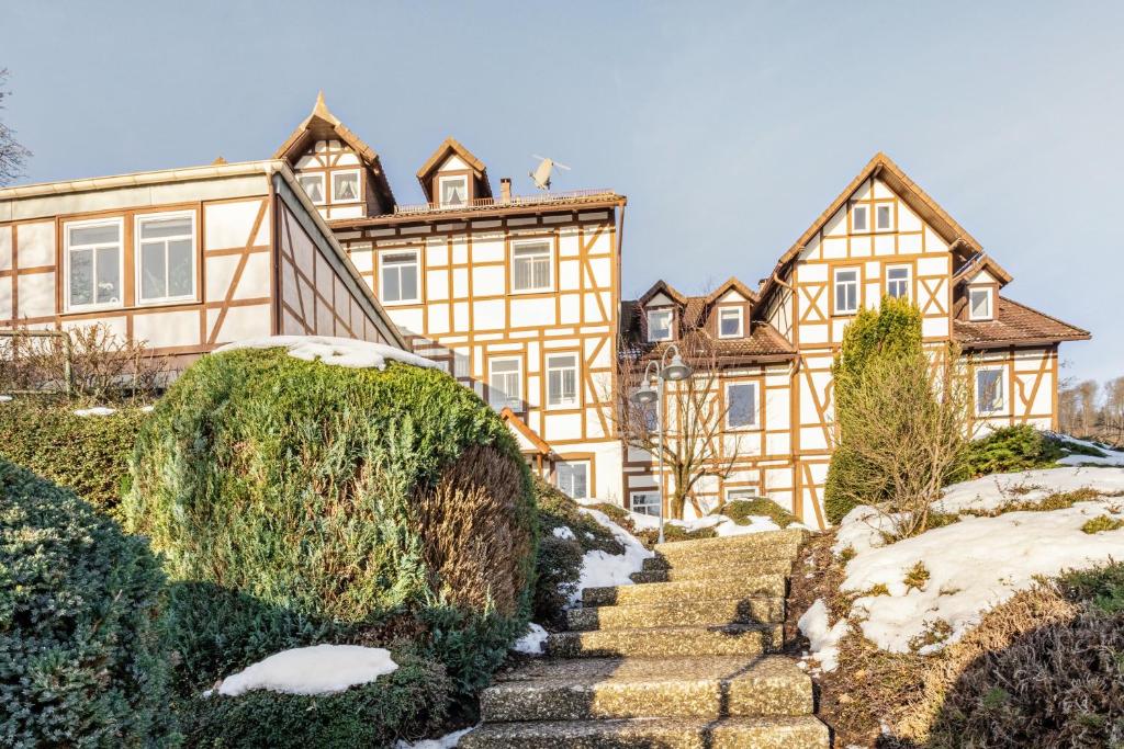a large house with stairs in front of it at Das Spatzennest in Bad Sachsa