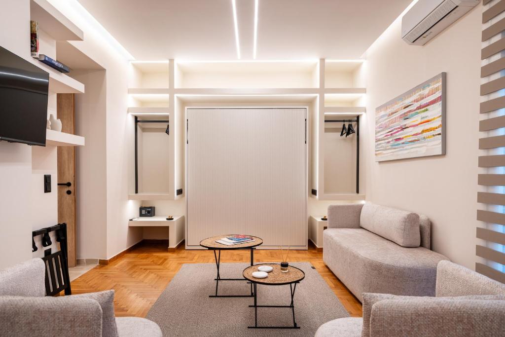 a living room with a couch and a table at The Apex Boutique Apartment B1 in Athens