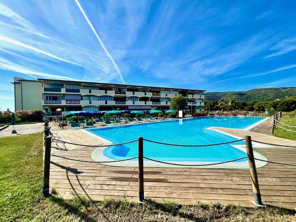 a large swimming pool in front of a building at Casa Verdeblu in Porto Azzurro