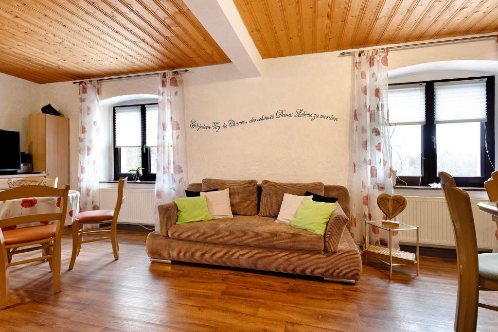a living room with a couch and some windows at Buchhaus Vier - Erdgeschoss in Kirchenlamitz