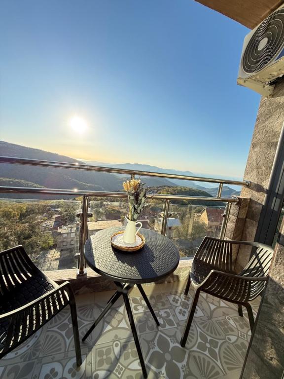 a table and chairs on a balcony with a view at Panoramic View apartment Seraidi Annaba in Annaba