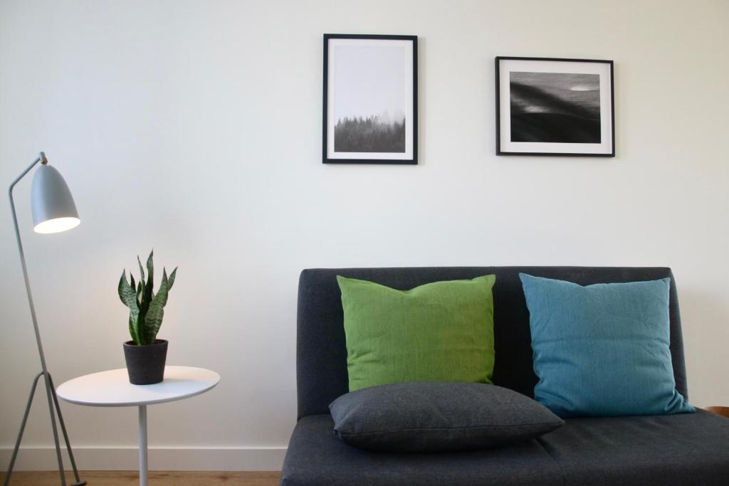 a living room with a couch and a table with a plant at Ferienwohnung An Der Dorfkirche in Vipperow