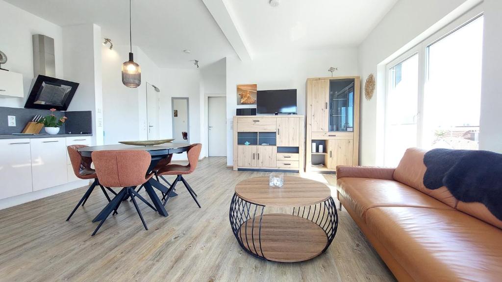 a living room with a couch and a table at Dinkelbach Feriendomicil 2 C in Lindau-Bodolz