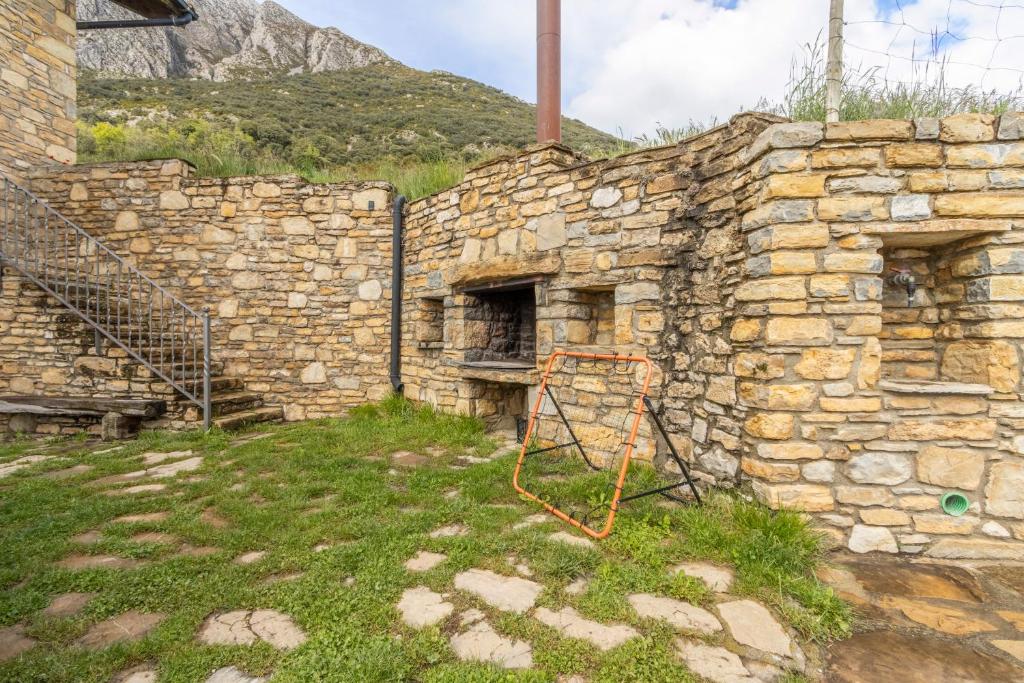 an old stone building with a staircase in a yard at Milano in Campo