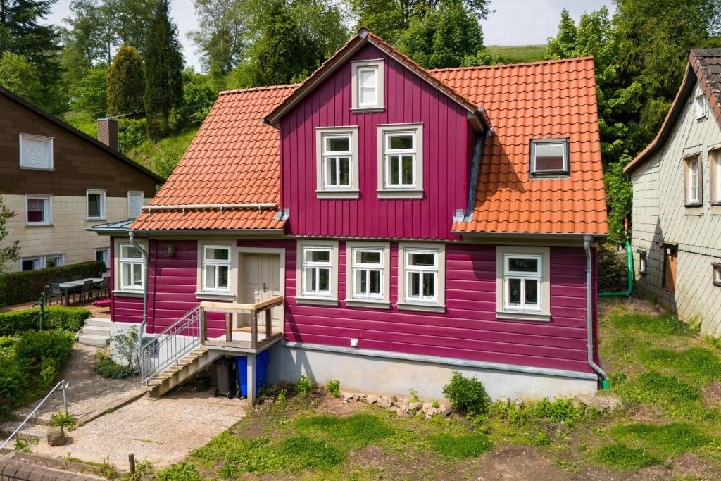 a purple house with an orange roof at Ferienhaus Bergmann mit Sauna in Wildemann