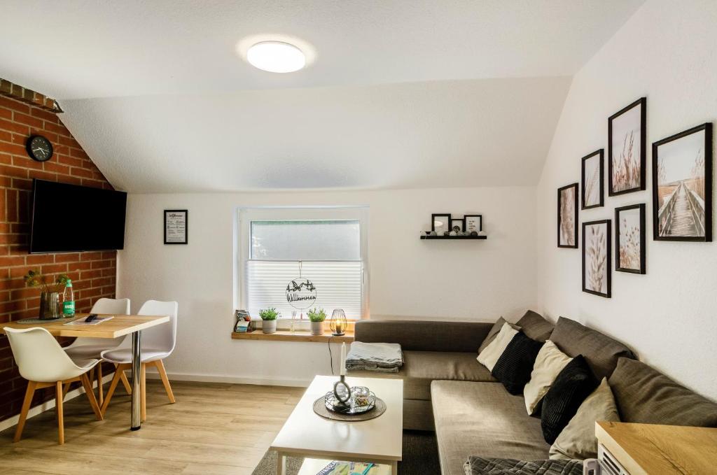 a living room with a couch and a table at Ferienwohnung Didi in Detern