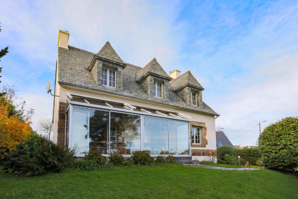 a house with a large window on the side of it at Les Camelias in Locquirec