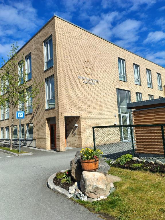 a brick building with a potted plant in front of it at Birgittaklosteret i Trondheim in Trondheim