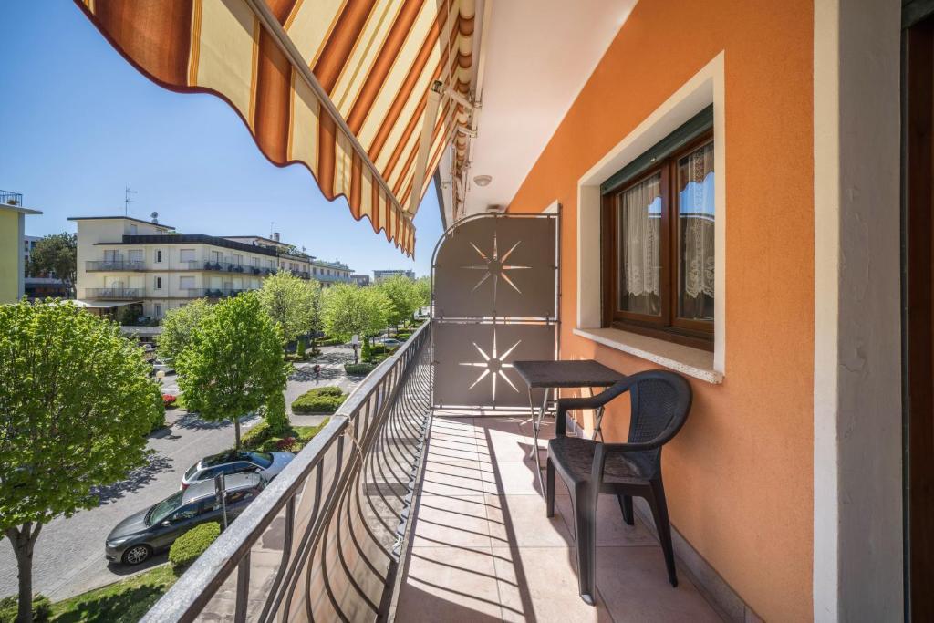 a balcony with a table and chairs on a building at Appartamento Croce del Sud 8 in Bibione