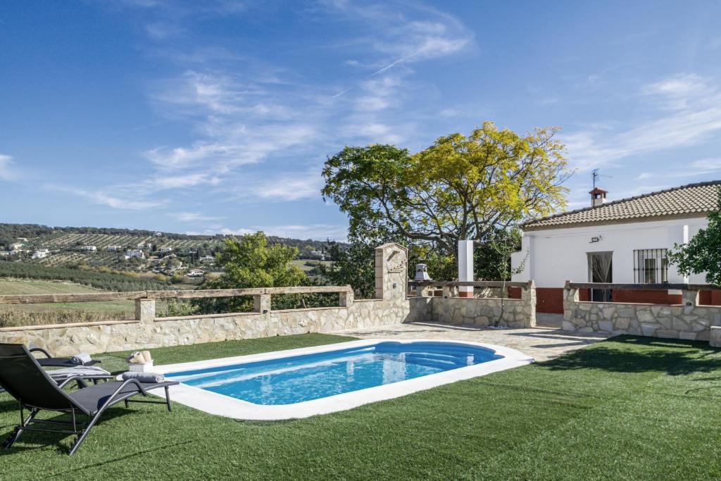 a swimming pool in the yard of a house at Casa Pilar in Ronda