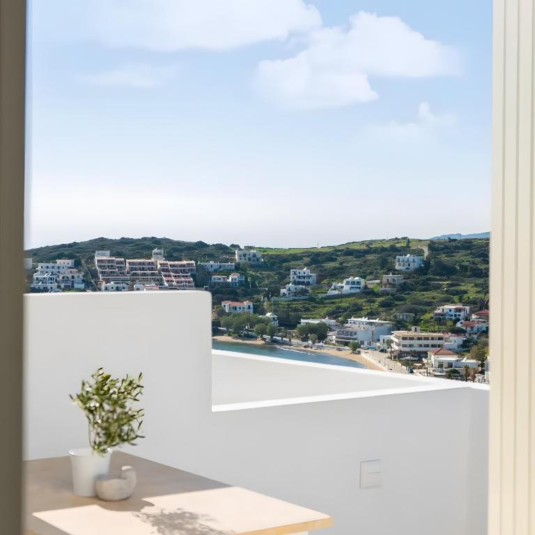 a view of a city from a window with a plant at Batsi view house in Andros