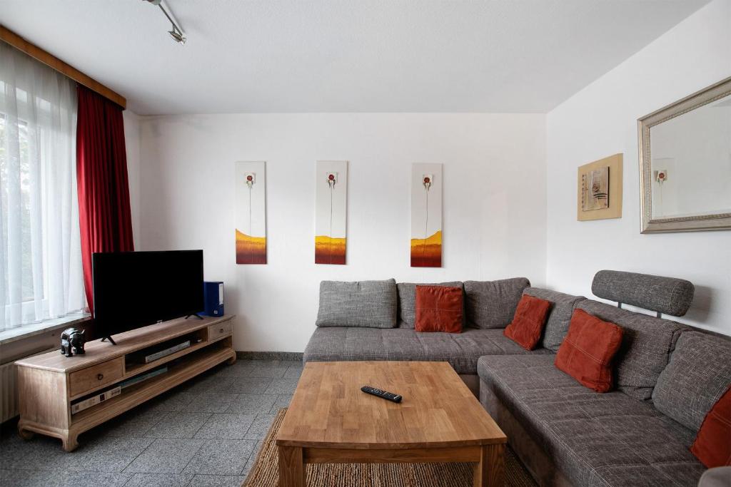 a living room with a couch and a television at Sylt Ferienwohnung 1 Westerland in Westerland