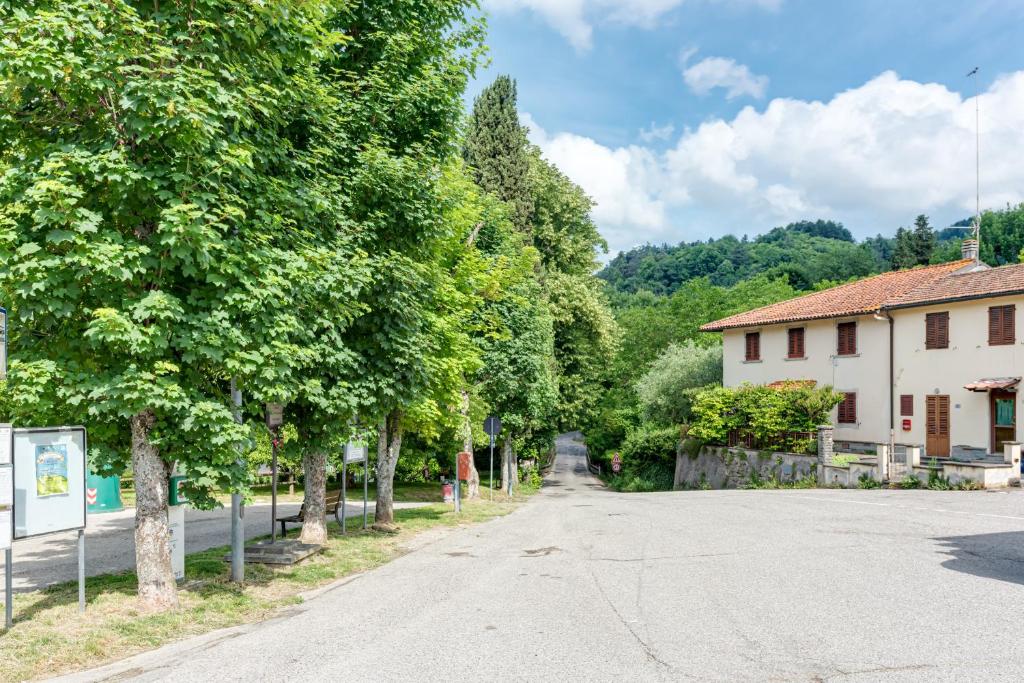 an empty street in a village with trees at Depandance Resort in Borgo San Lorenzo