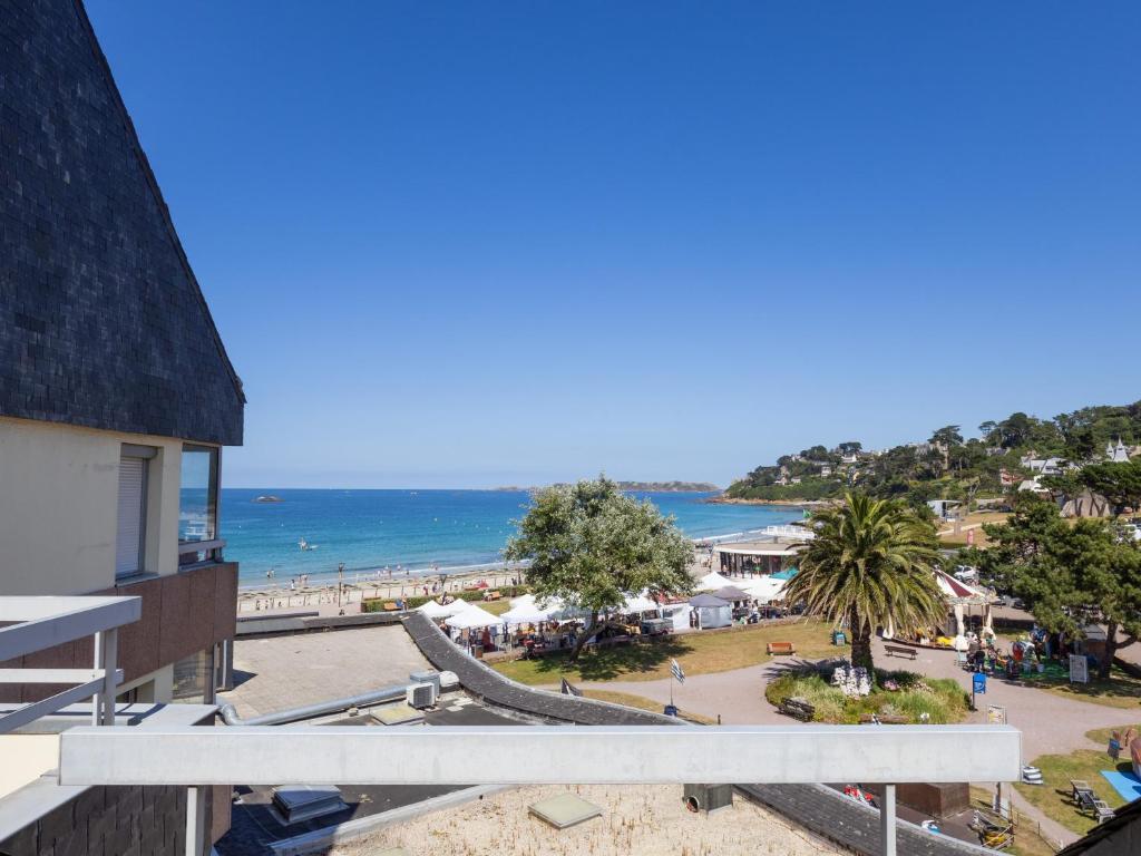 a view of the beach from the balcony of a resort at Ty Fox by Madame est Servie in Perros-Guirec