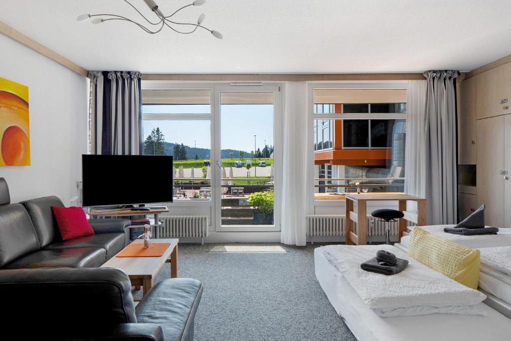 a living room with a couch and a tv at Fewo Berggipfel am Feldberg in Feldberg