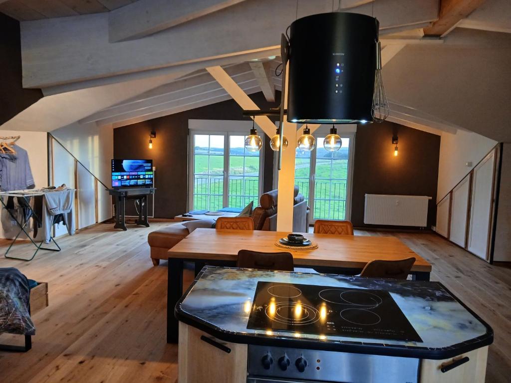 a kitchen and living room with a stove at Hof Sorgenfrei in Buch