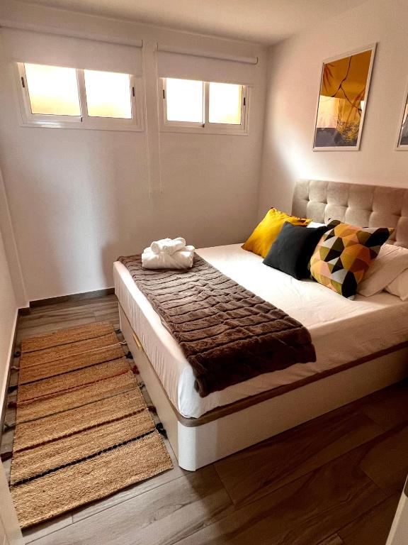 a bedroom with a large bed with a rug at Bluebell L6 in Armeñime