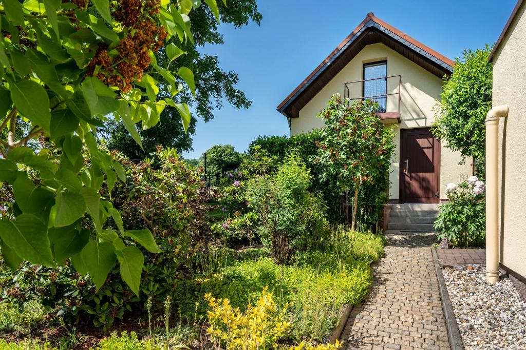 a house with a garden and a walkway at Ferienwohung Marion - Hohnstein in Rathewalde