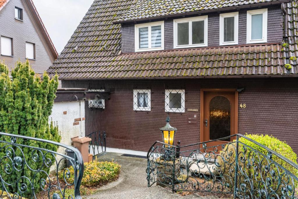 a house with a gate in front of it at Ferienhaus Burghalde mit Sauna in Alpirsbach