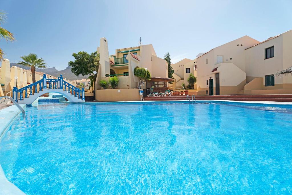 a large swimming pool with blue water in a resort at Mareverde K130 in Adeje