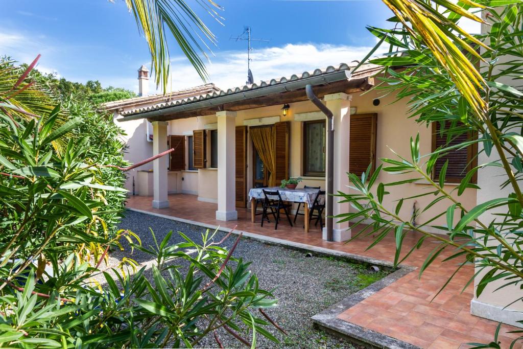 a house with a patio and a table in front of it at Bilo Hedera in Marina di Grosseto