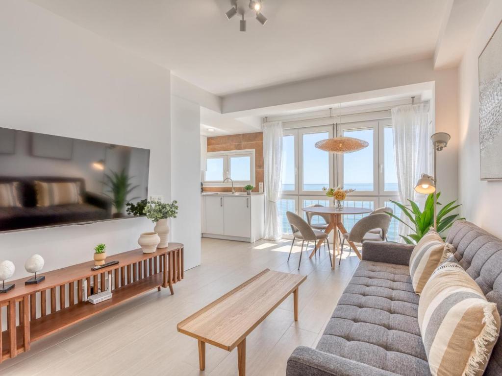 a living room with a couch and a table at Hanami Avenida de España Oceanfront in Estepona