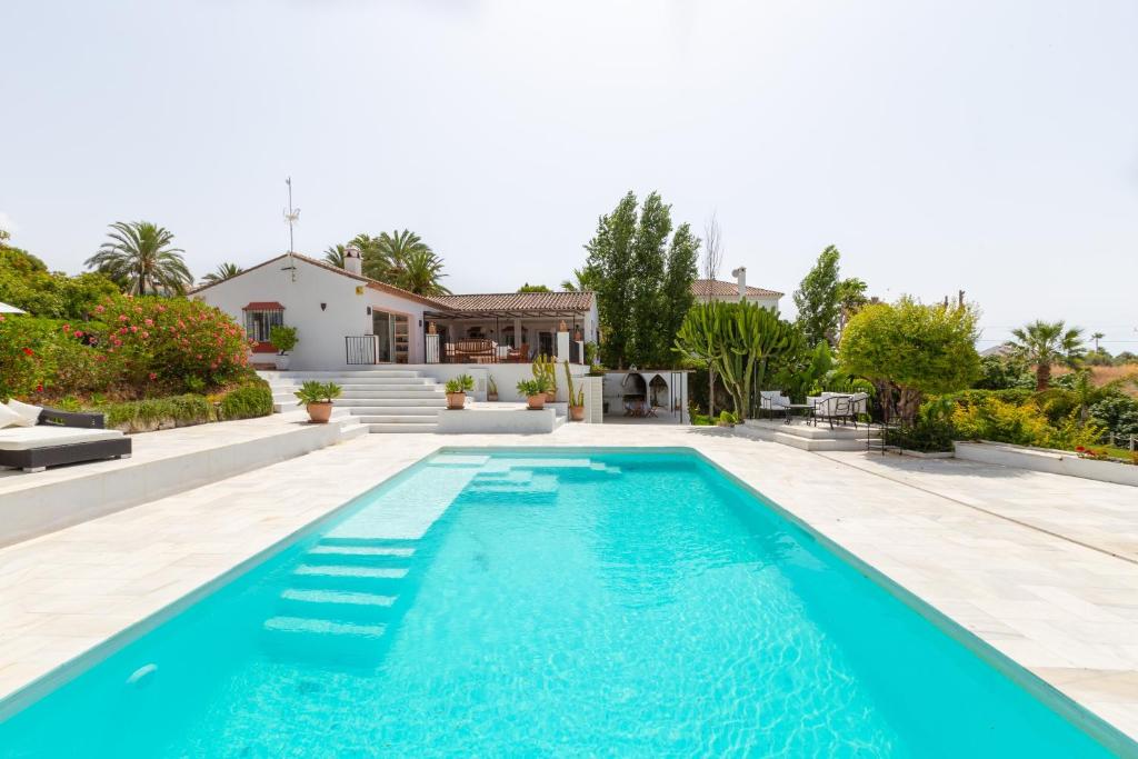 a swimming pool in the backyard of a house at Almijan Alegria in Estepona