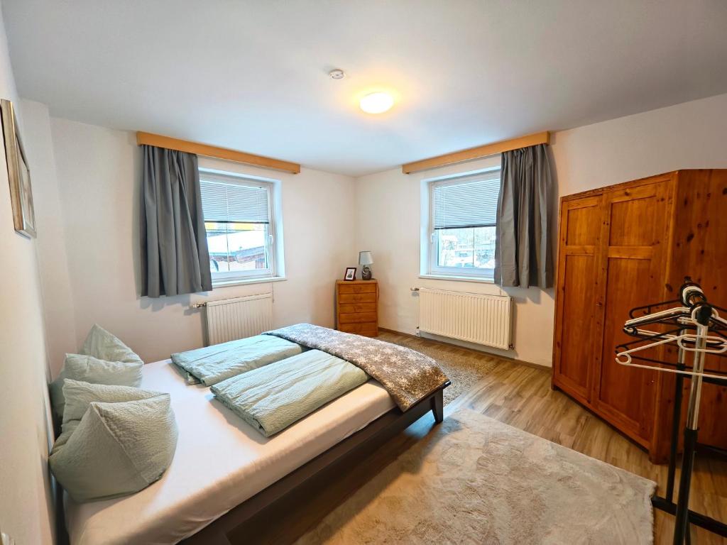 a bedroom with a bed and two windows at Apartment Gina in Stall