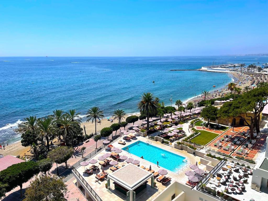 an aerial view of a resort with a swimming pool and the ocean at Apartment with Swimming-pool in Marbella