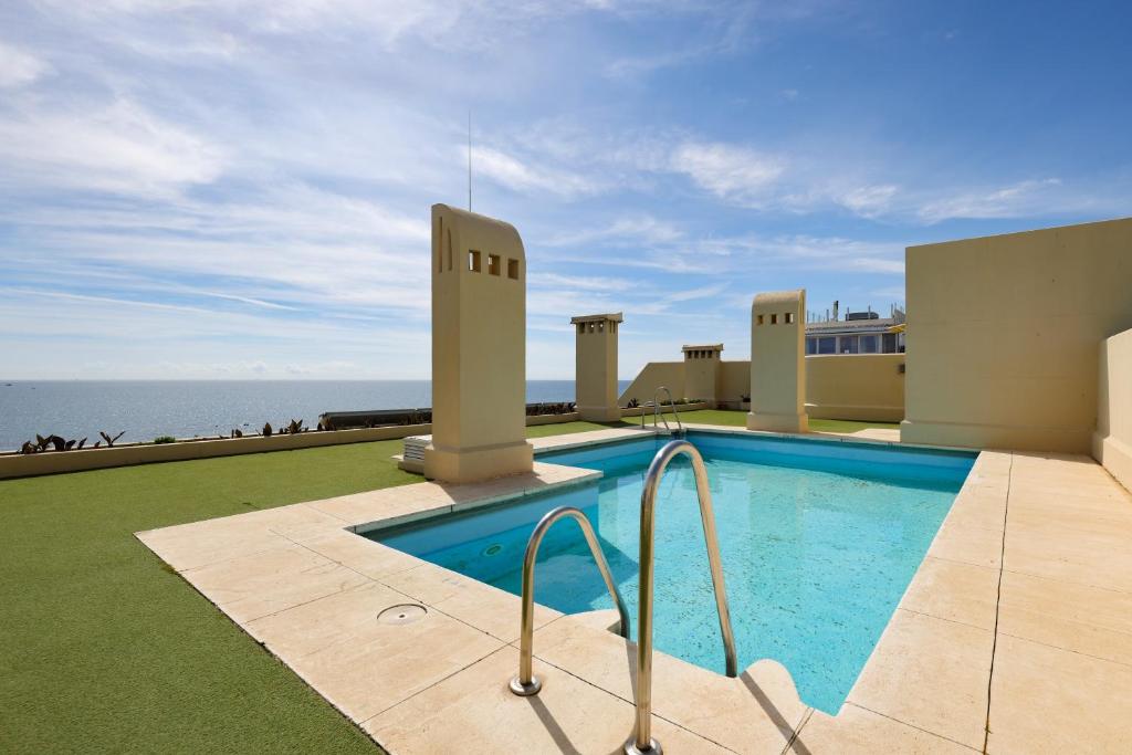 a swimming pool with a view of the ocean at Apartment - Car included in Estepona