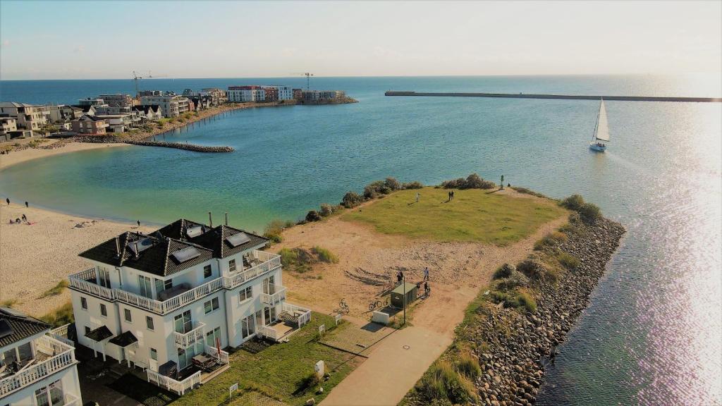 an aerial view of a house next to a body of water at Strand Hus by Seeblick Ferien in Olpenitz