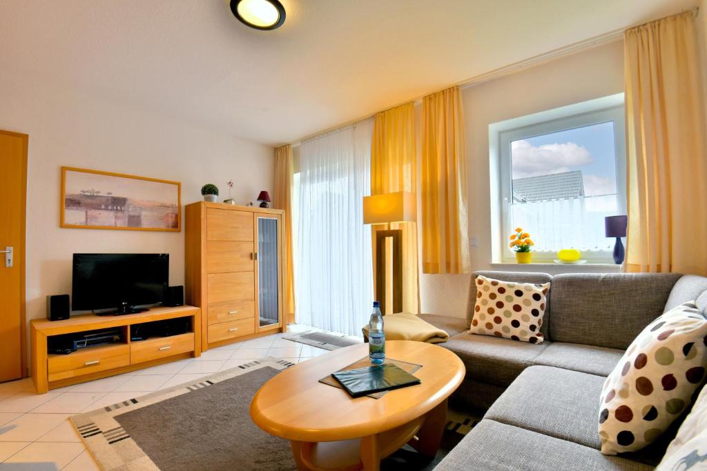 a living room with a couch and a table at Ferienwohnung Tannenblick 3-3 in Oberhof