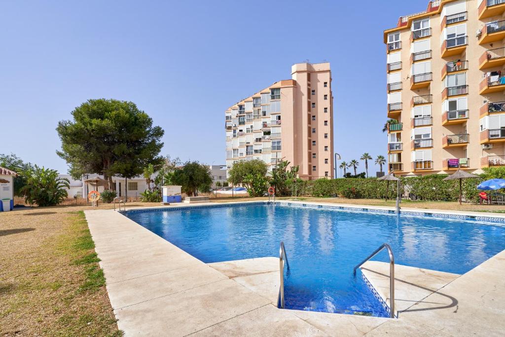 a swimming pool in front of a apartment building at Estudio El Faro 2 in Torrox