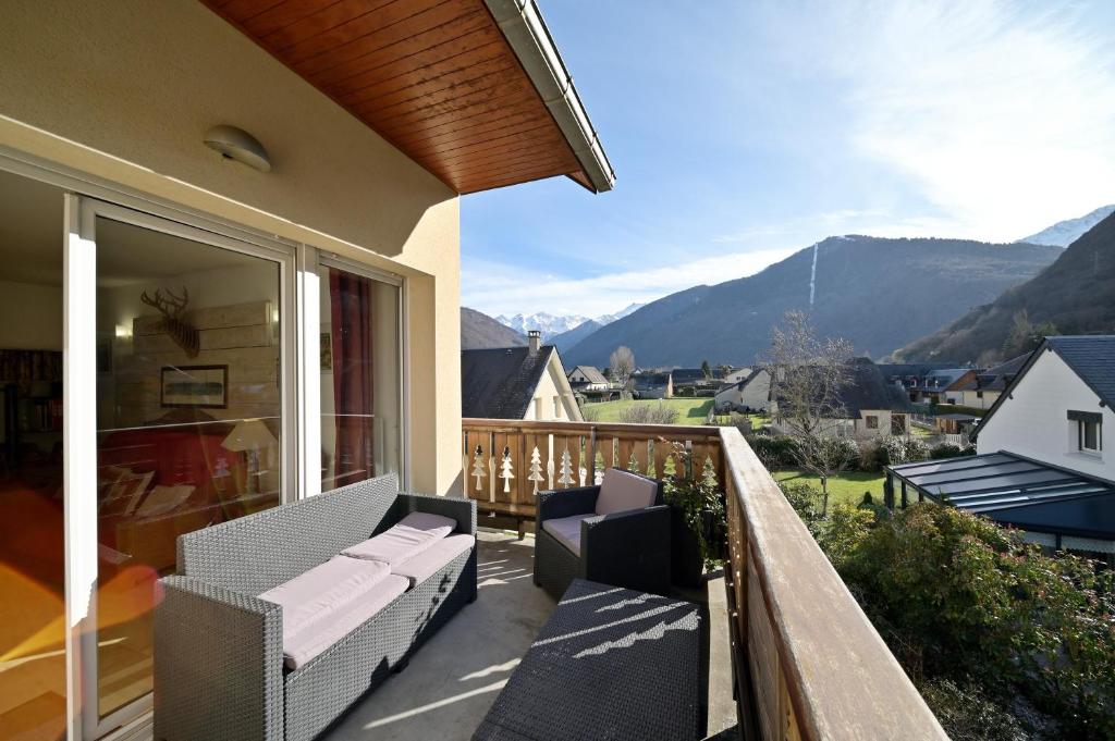 a balcony with chairs and a view of mountains at A 208 Pics D'aran in Luchon