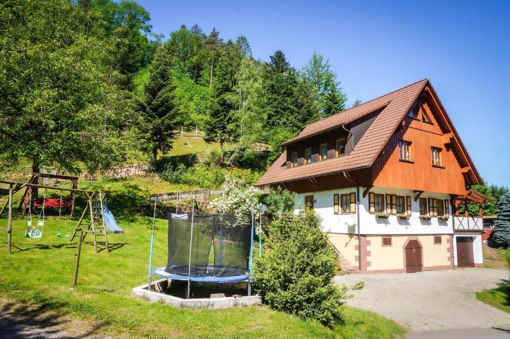 a house with a playground in front of it at Wellehof in Oberkirch