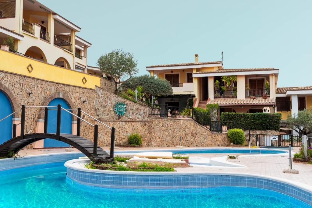 a swimming pool in front of a building at Dimora Frau in Villasimius