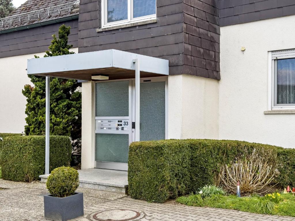a door of a house with bushes in front of it at Ferienwohnung am Bächler in Hagnau