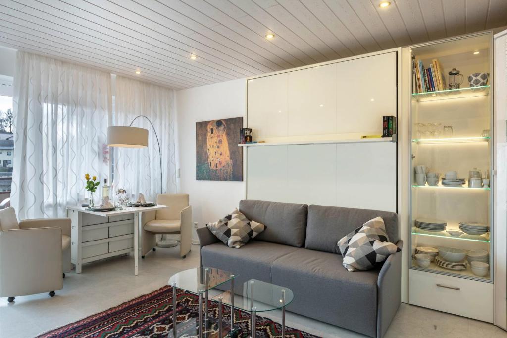 a living room with a couch and a table at Ferienwohnung Urs in Schönwald