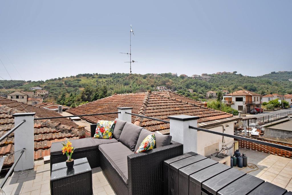 a balcony with a couch on top of a roof at Casa Leah in Imperia